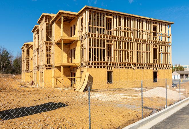 workers protected by temporary barrier fence during building maintenance in Haslet TX